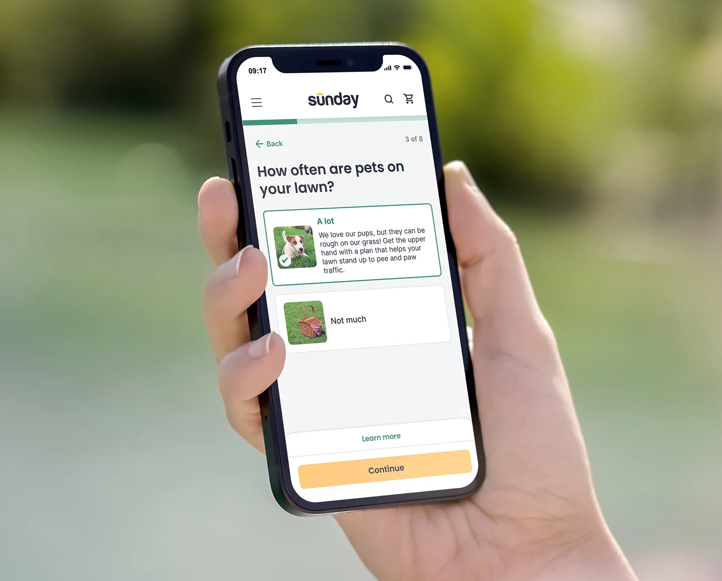Hand holding a smartphone with the Sunday app asking how often pets use the lawn