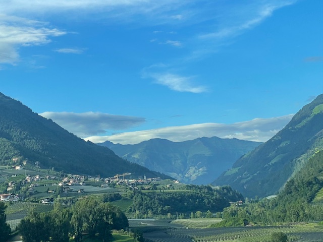 Mountain valley with small town nestled among green forested hills