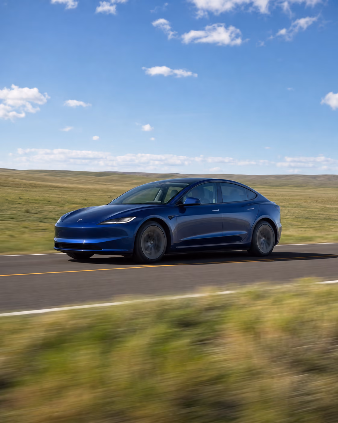 Tesla Model S cruising on mountain highway