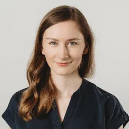 Portrait of a Agnieszka, a female UX/UI designer with a professional, focused expression, wearing a dark shirt.