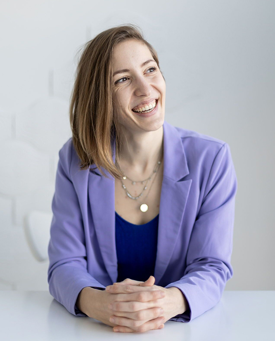 Headshot of Mina Nabinger, Accessibility Consultant, a white woman with a buzzcut on the sides and slightly longer on top looking to the right of the camera.
