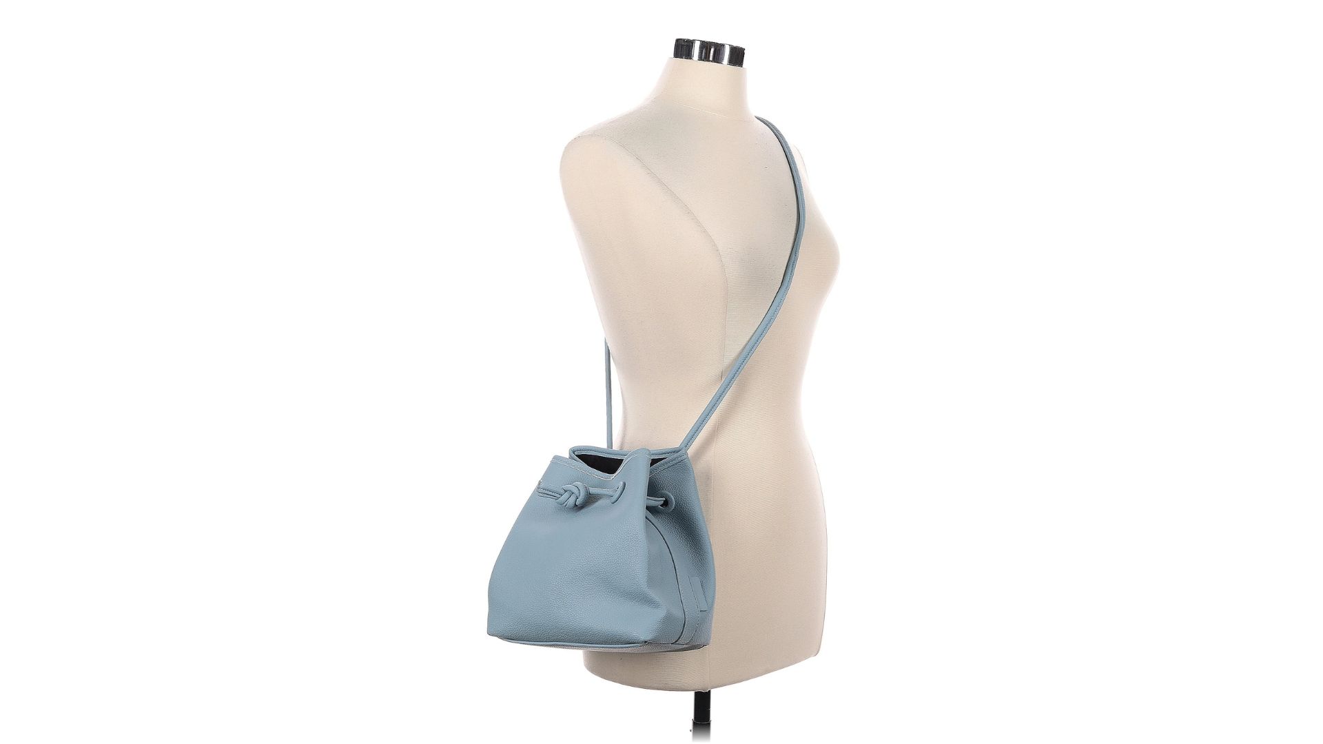 A light blue bucket bag hanging from the strap on a torso-only mannequin.