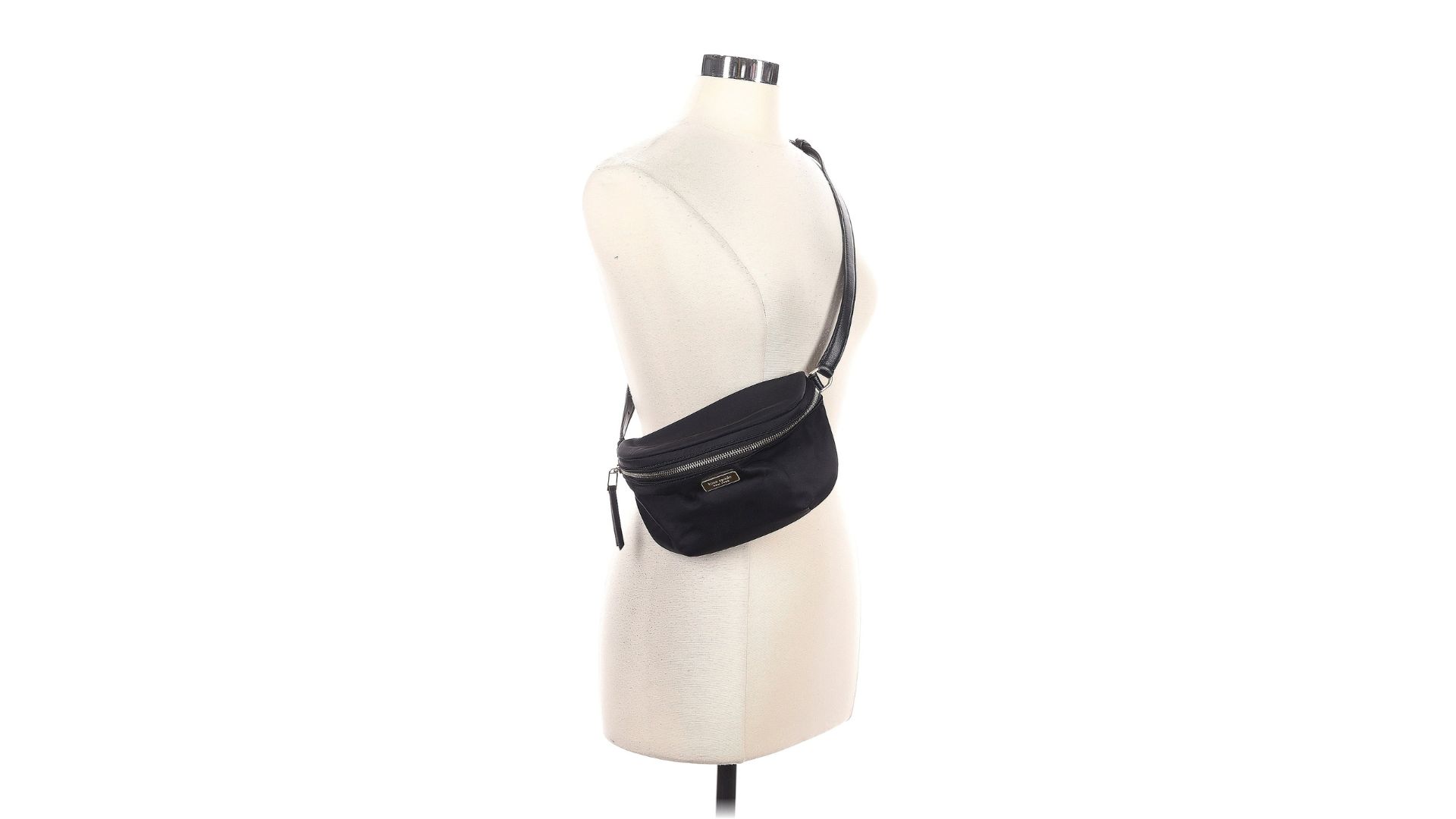 A black belt bag hanging across a torso-only mannequin and featuring 'Kate Spade New York' on the front.