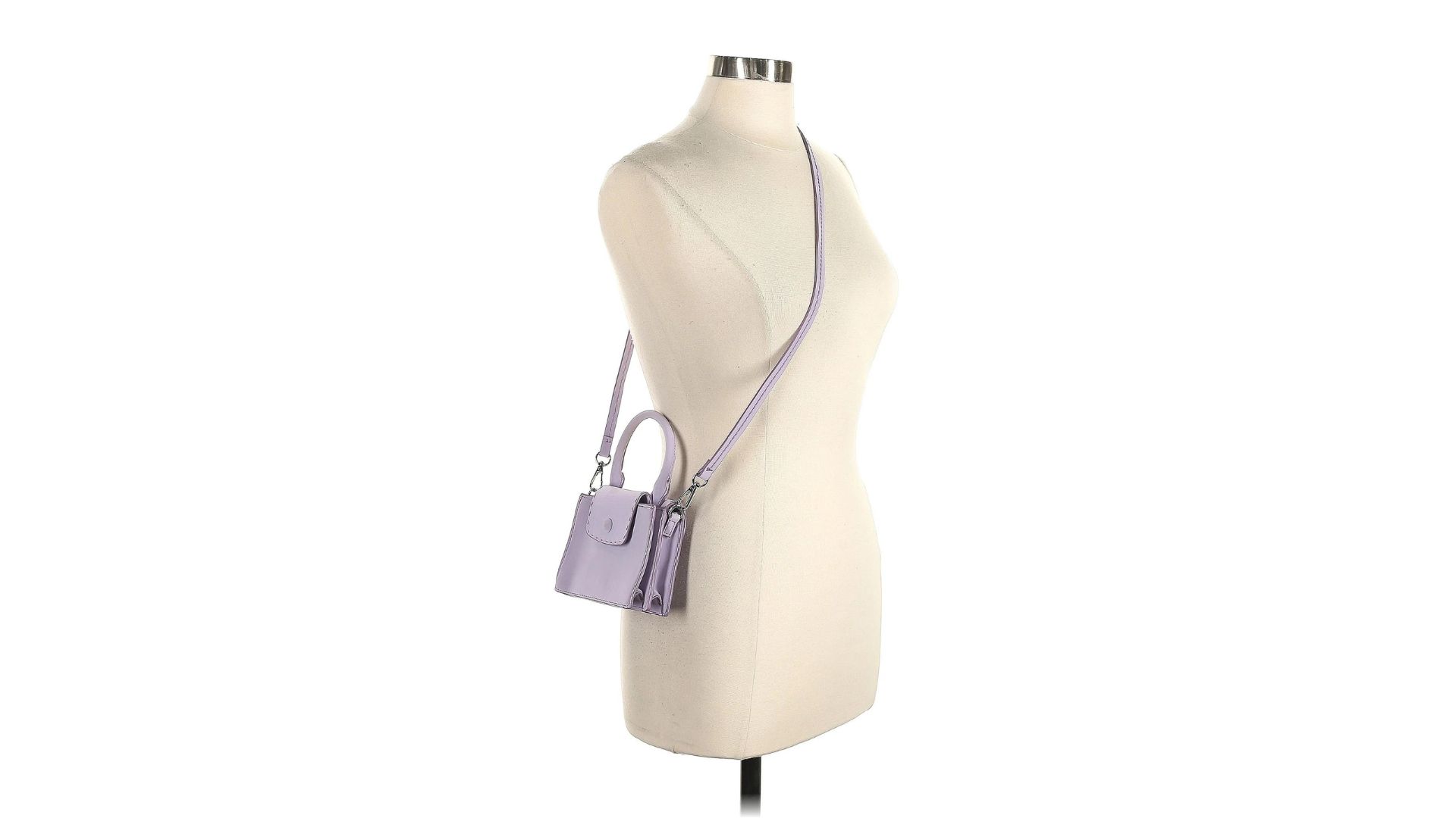 A purple satchel bag hanging from the strap on a torso-only mannequin.