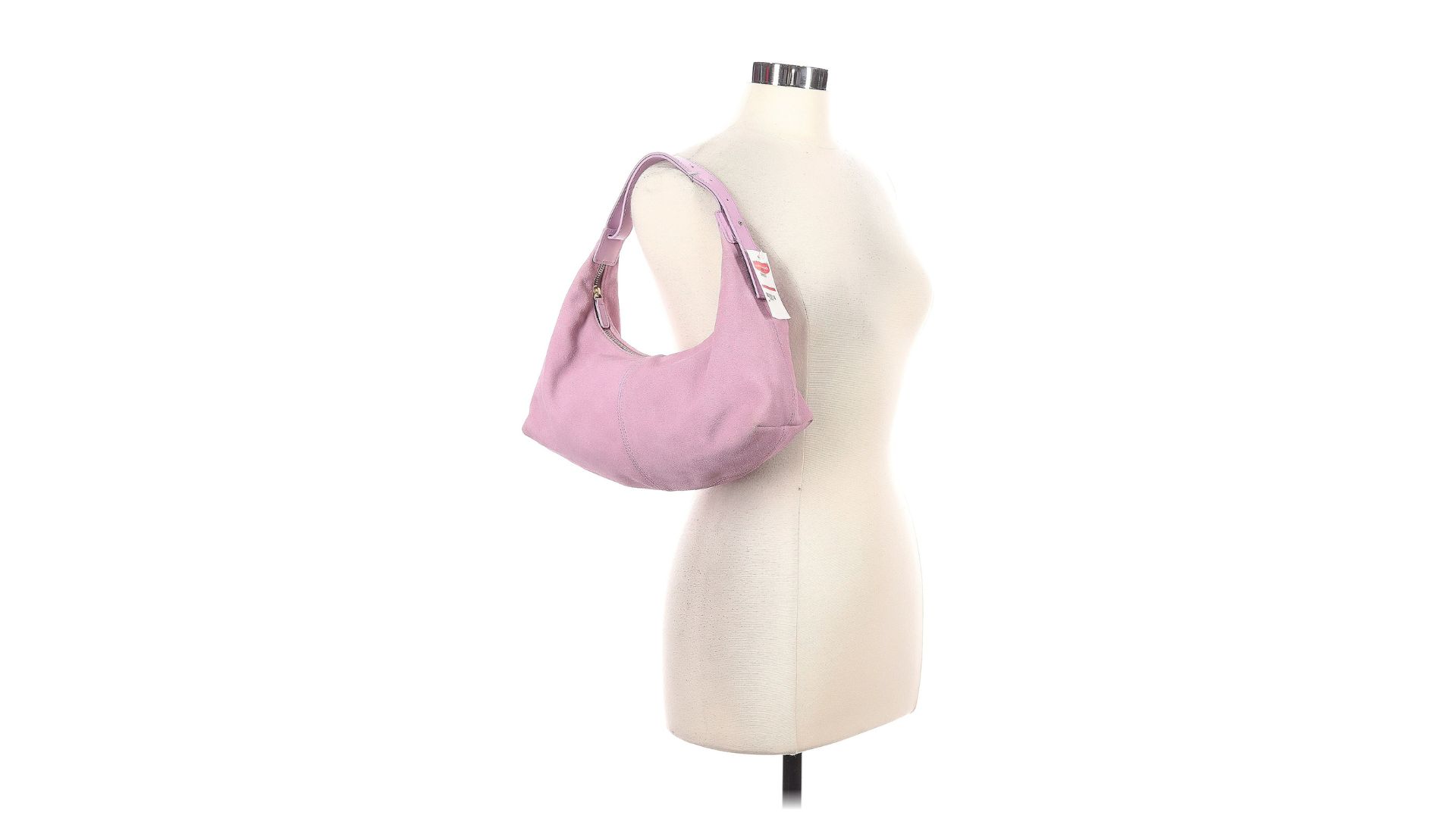 A pink hobo bag hanging from the strap on a torso-only mannequin.