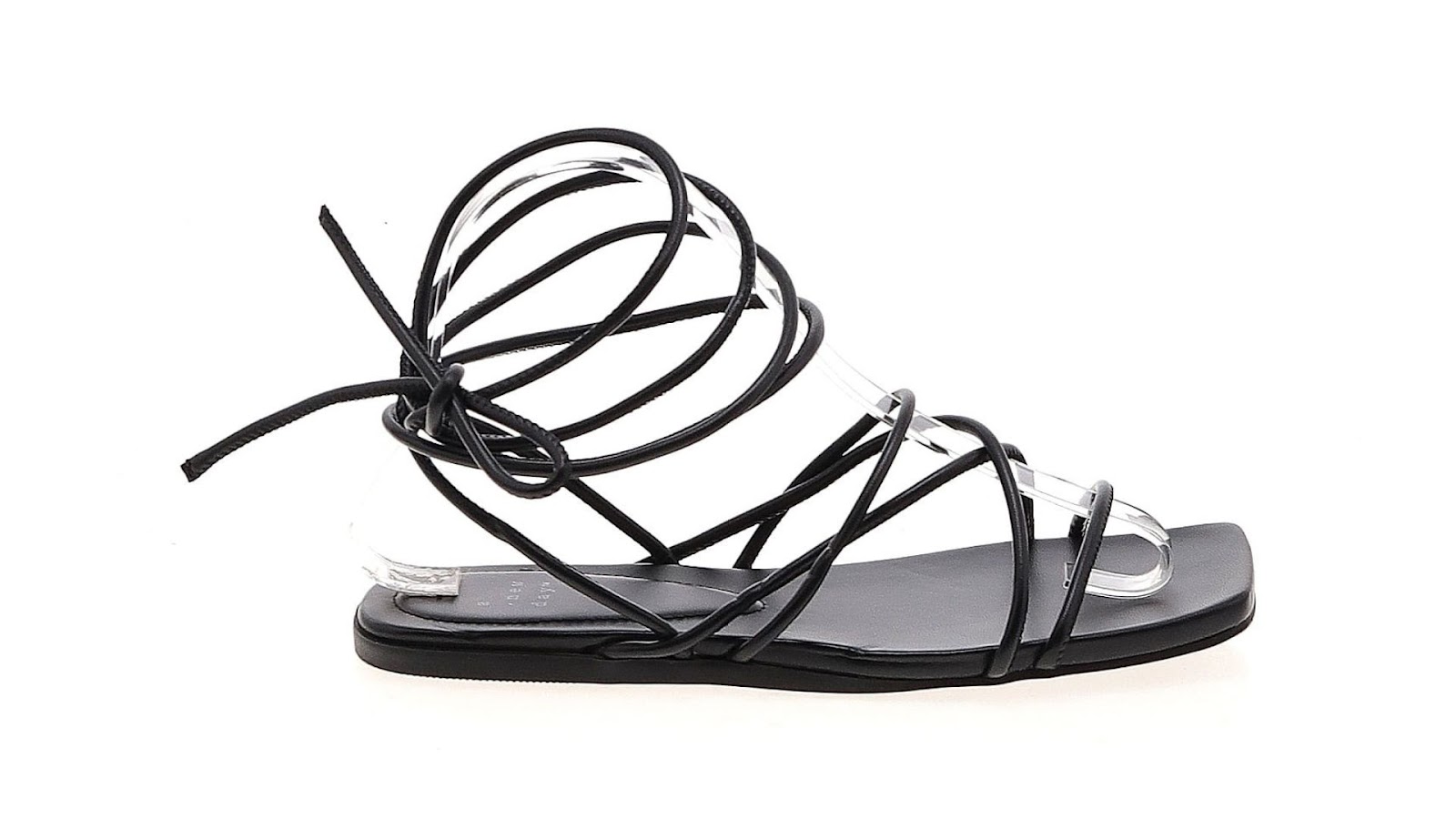 A black strappy sandal on a white background.