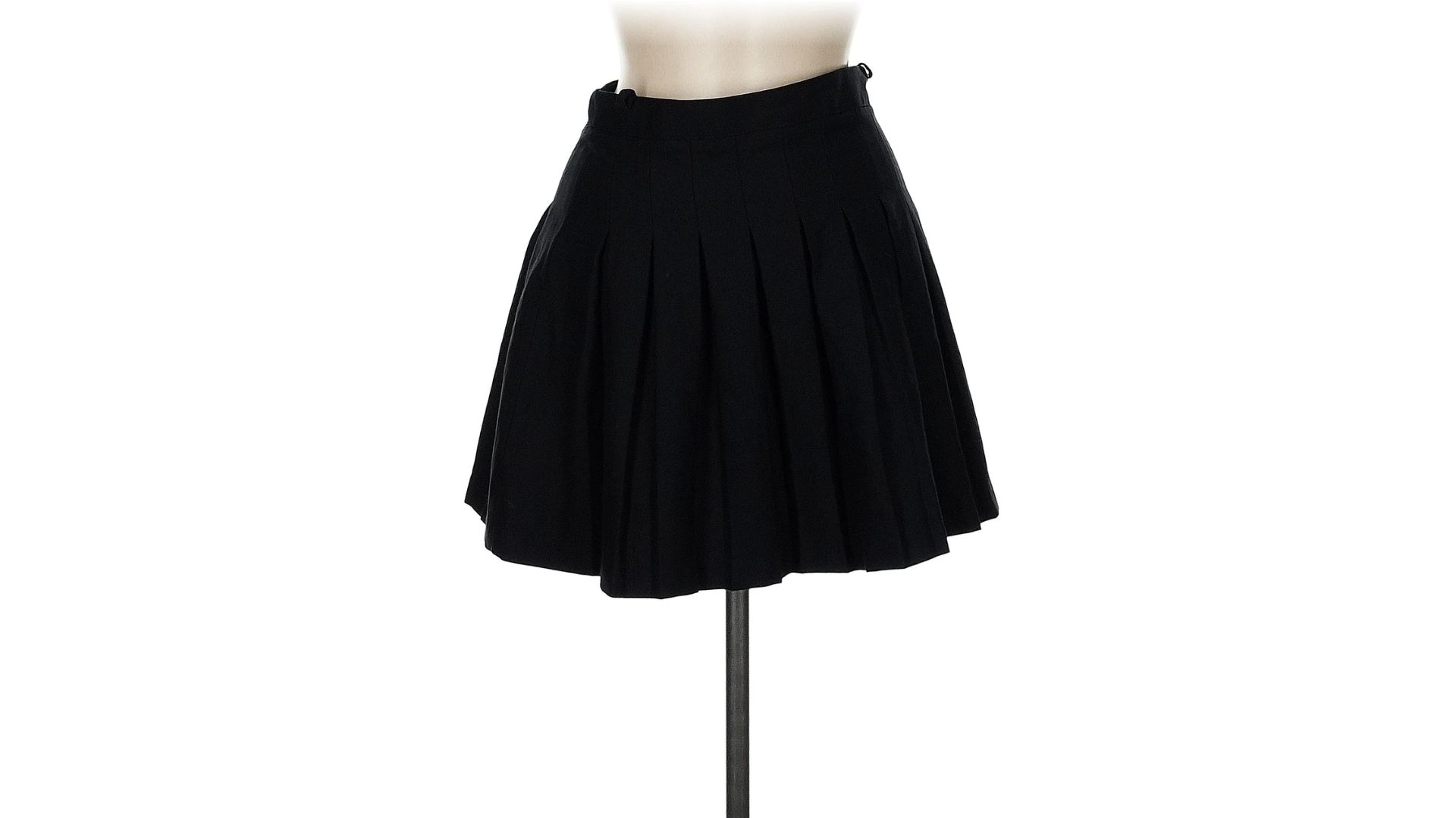 An image of a black mini skirt from Urban Outfitters displayed on a mannequin against a white background.