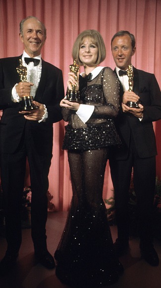 Barbra Streisand in the 1969 Oscar's red carpet with a sheer, sequined pantsuit.