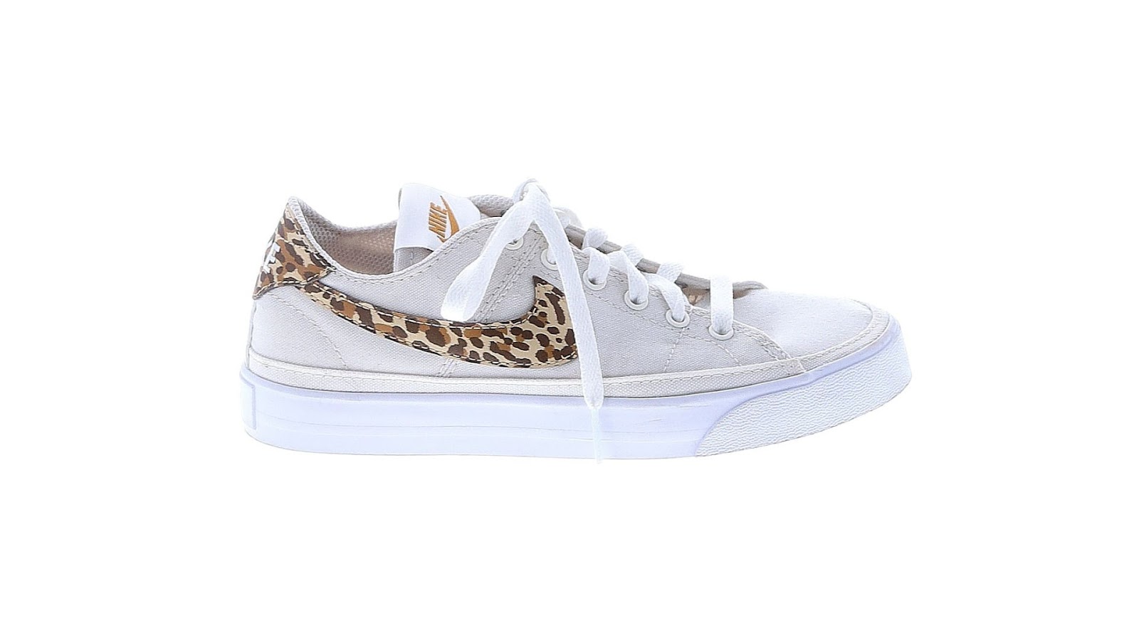 A white Nike sneaker with animal print design on the logo.