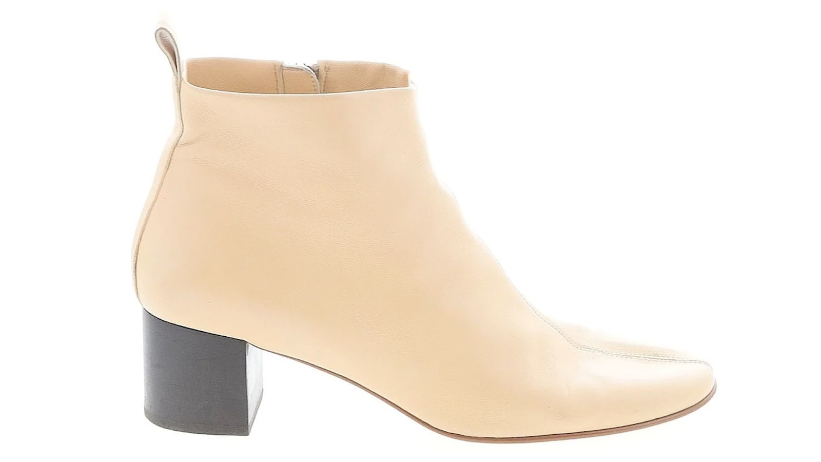 A cream ankle boot against a white background.