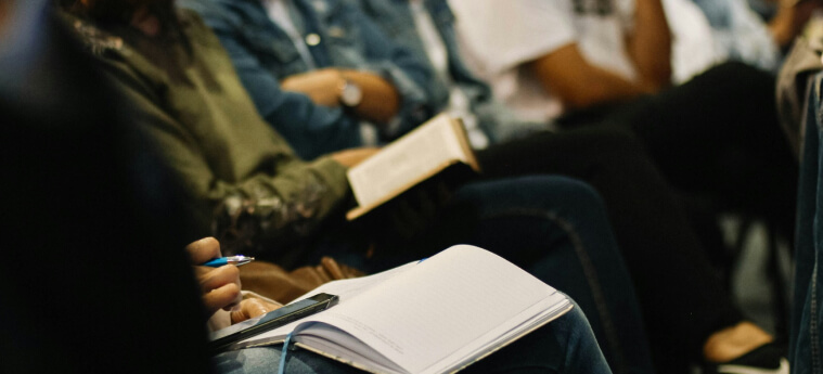 Team members taking notes in a training session – building communication and collaboration skills