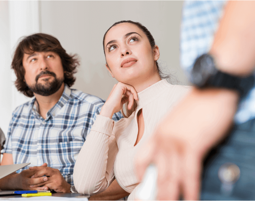Woman listening attentively, engaged and learning in a meeting – developing confident communication skills