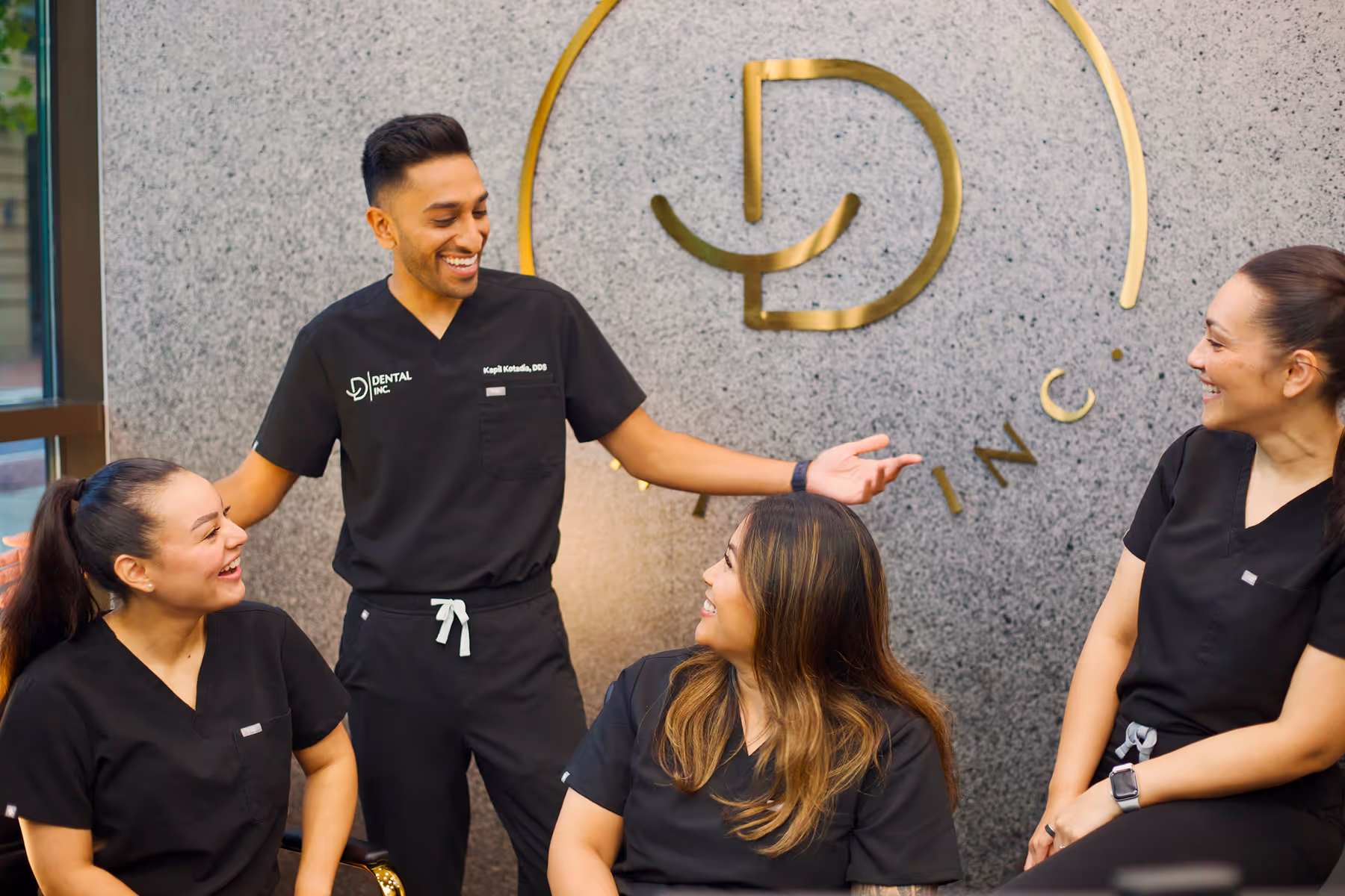 A group of people sitting around each other.