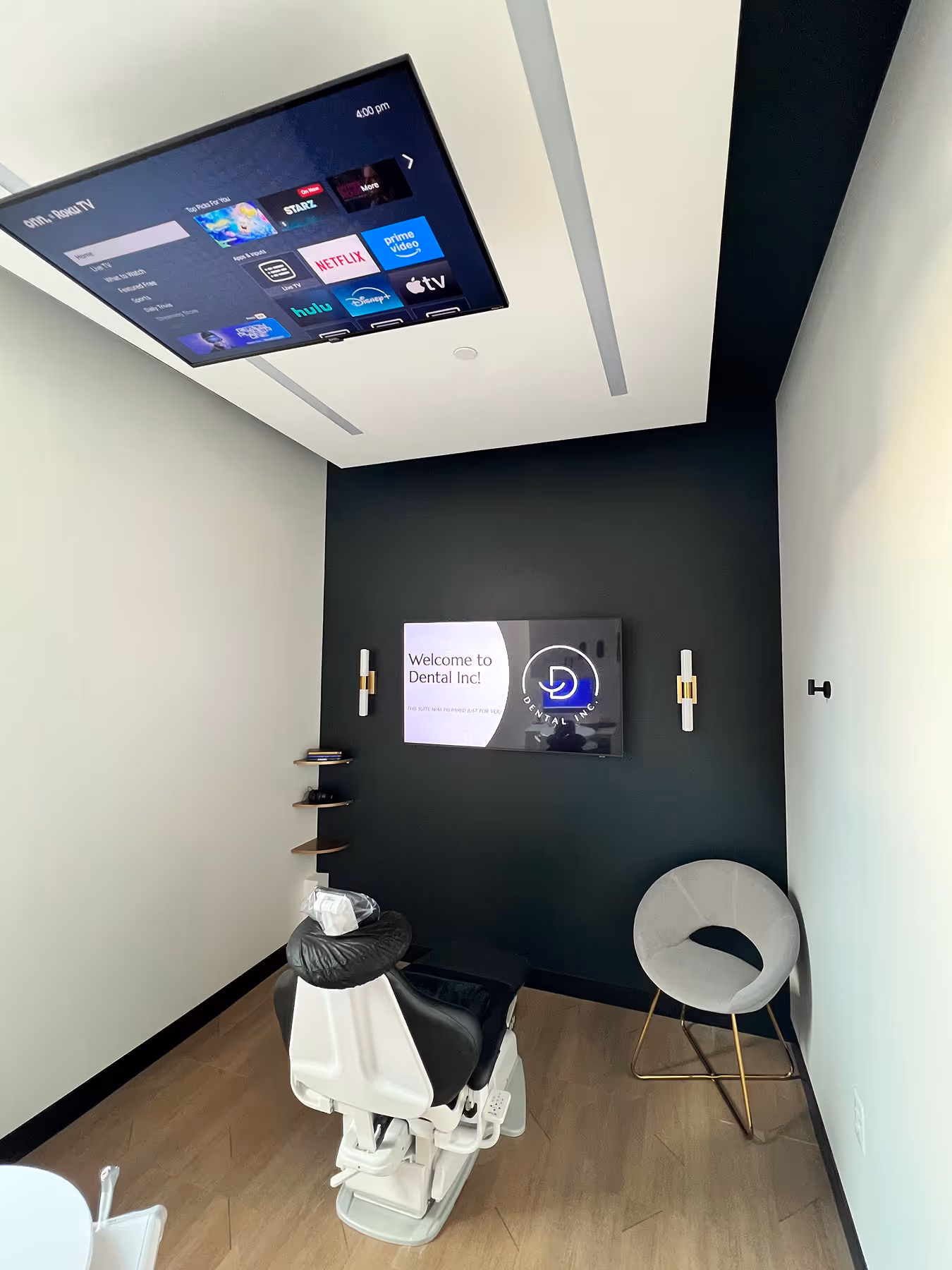 A room with a tv and a white chair.