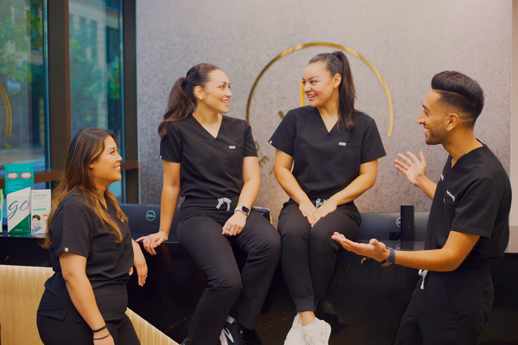 A group of people sitting on top of a bench.