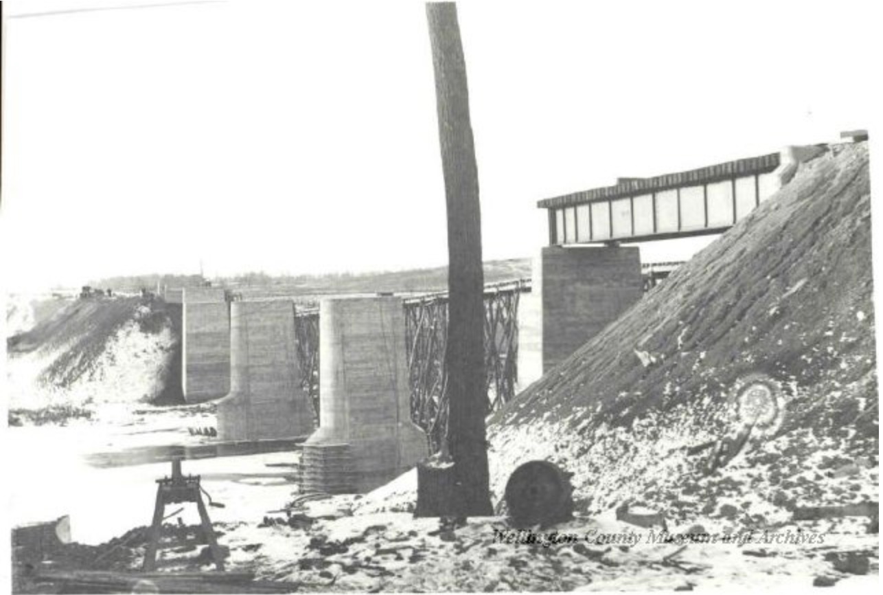 Historic construction view of the former railway bridge footings across the Grand River