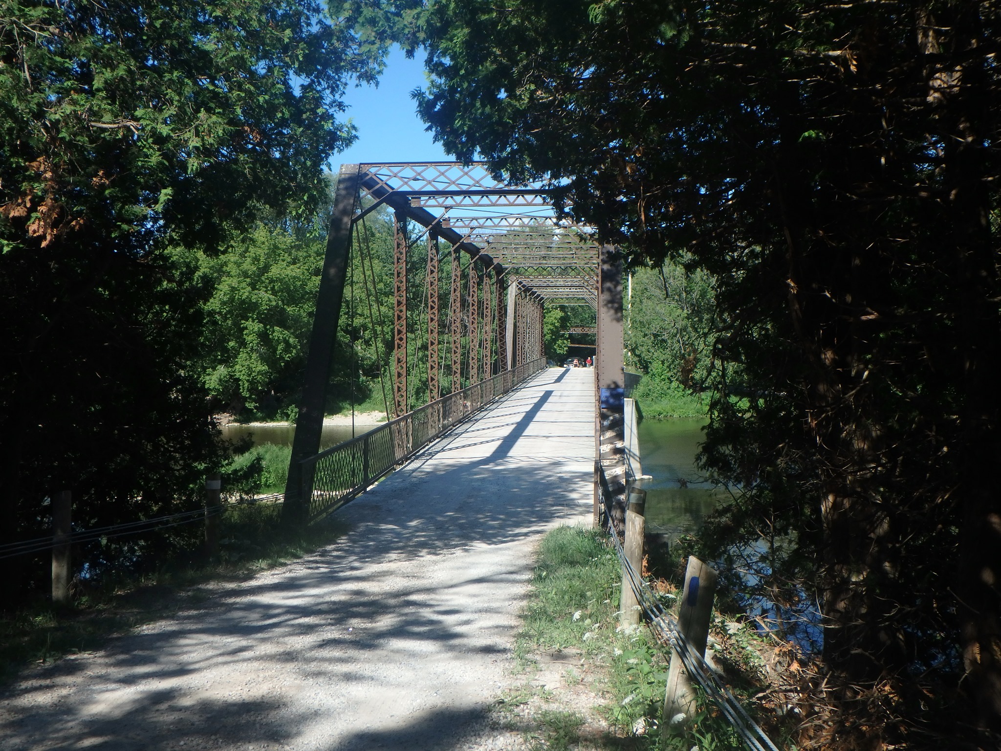A bridge on the G2G Rail Trail framed by summer trees