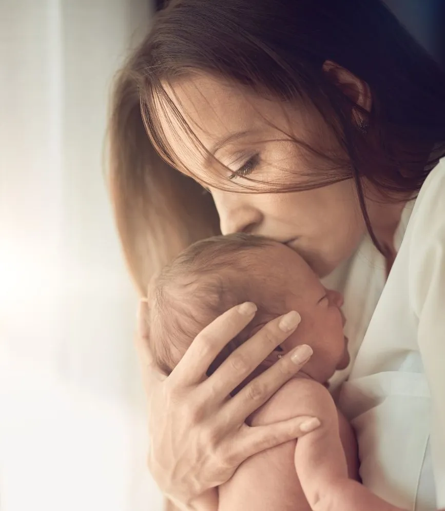 Mother and child sharing a warm embrace, representing healing and connection through ART therapy in California