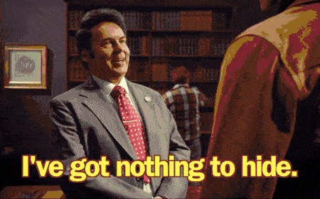 Man in suit with red polka dot tie standing in office saying 'I've got nothing to hide' from BBC's Top Coppers