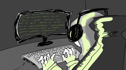 Hooded developer in headphones typing at a keyboard with green code flowing across a dark curved monitor.