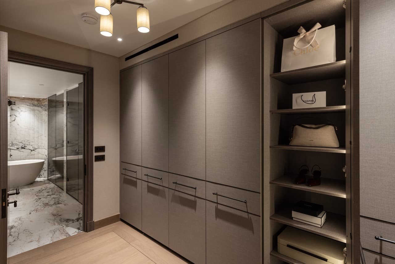 Dedicated walk-in wardrobe with full-height fitted storage