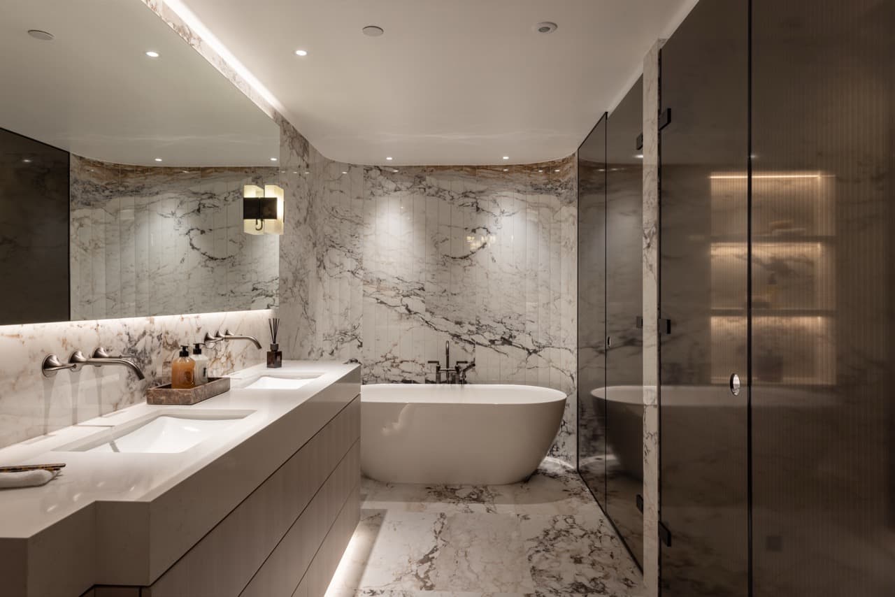 Principal ensuite with twin basins, a freestanding bath and a separate shower