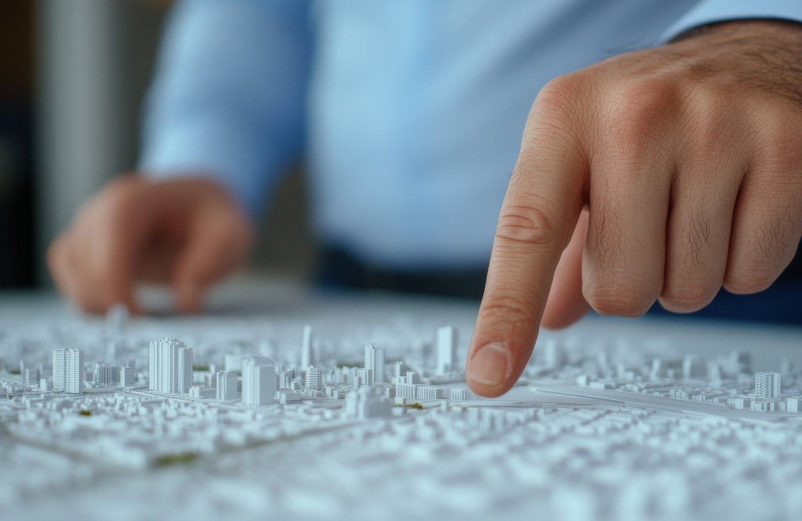 finger pointing at city 3d model