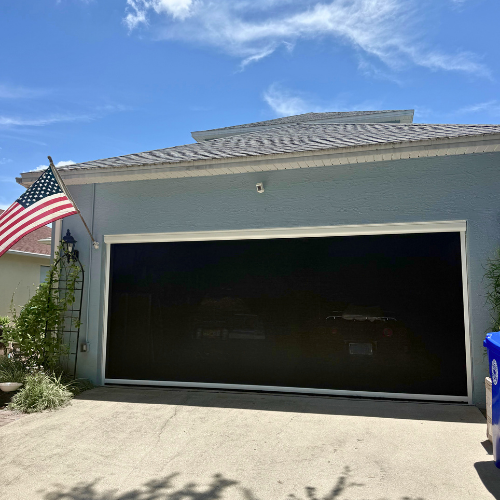 Black Magnatrack motorized hurricane garage screen in Cocoa, FL. 
