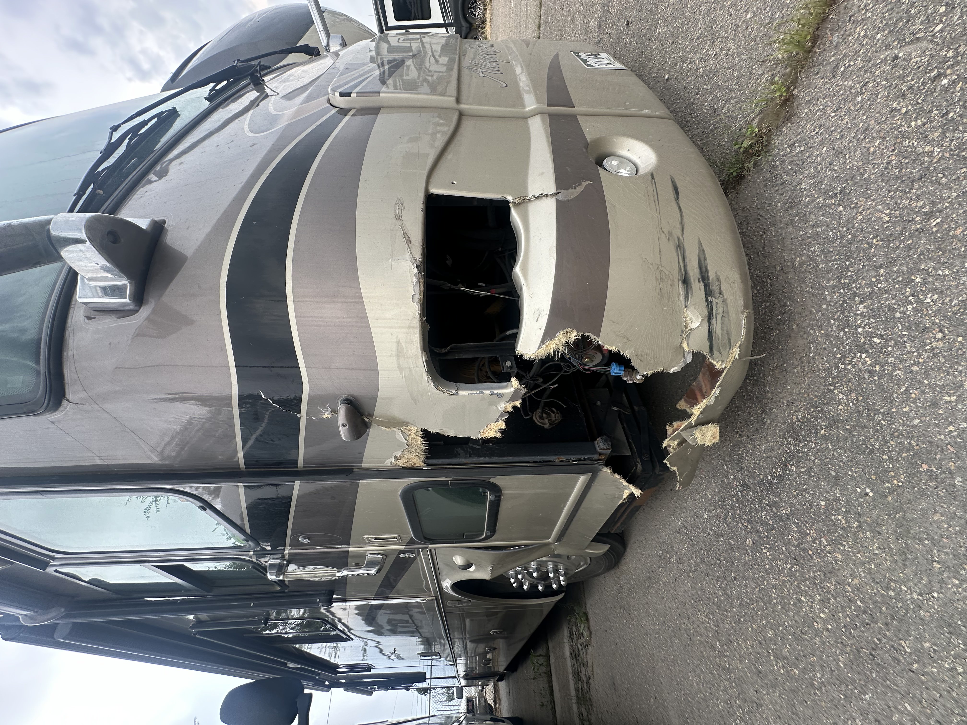 A motorhome with severe fiberglass damage waiting to be repaired at Fiberglass Worx