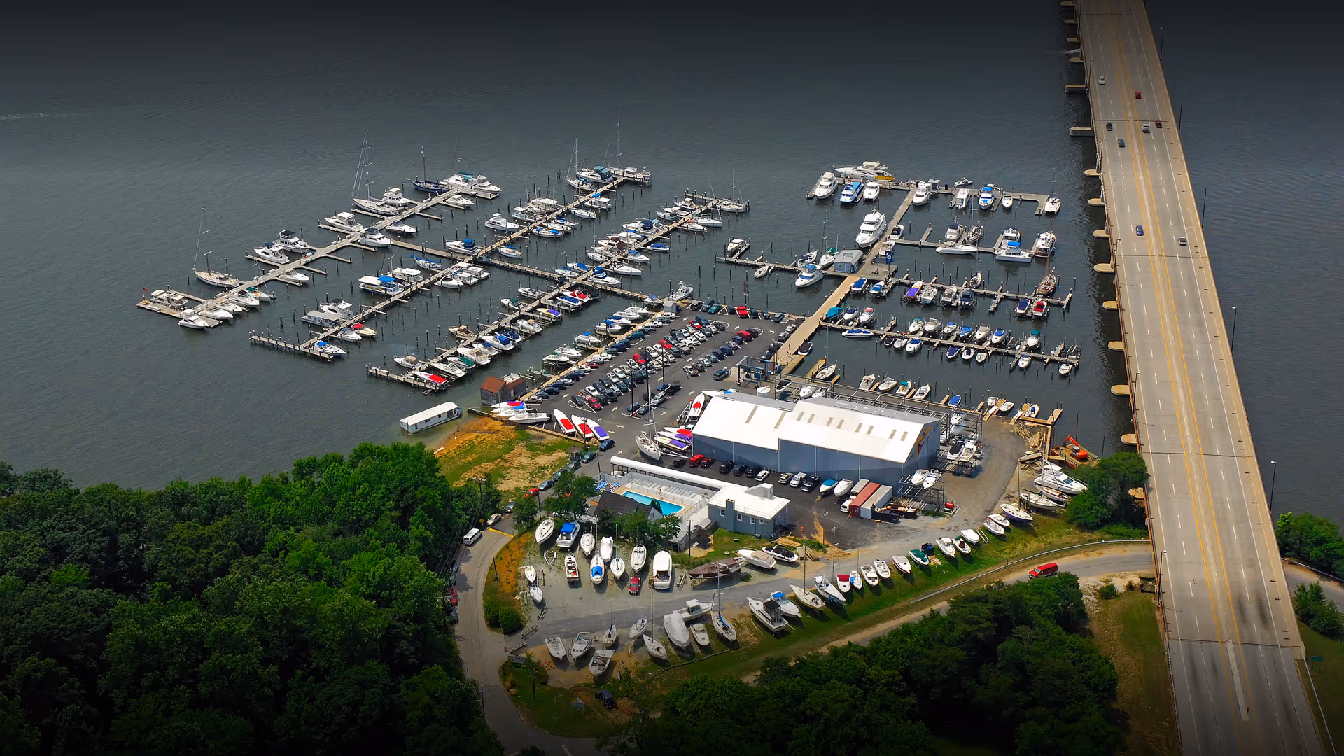 Aerial view of Liberty Marina showing boat slips, land storage area, and waterfront location on the South River in Edgewater, Maryland.