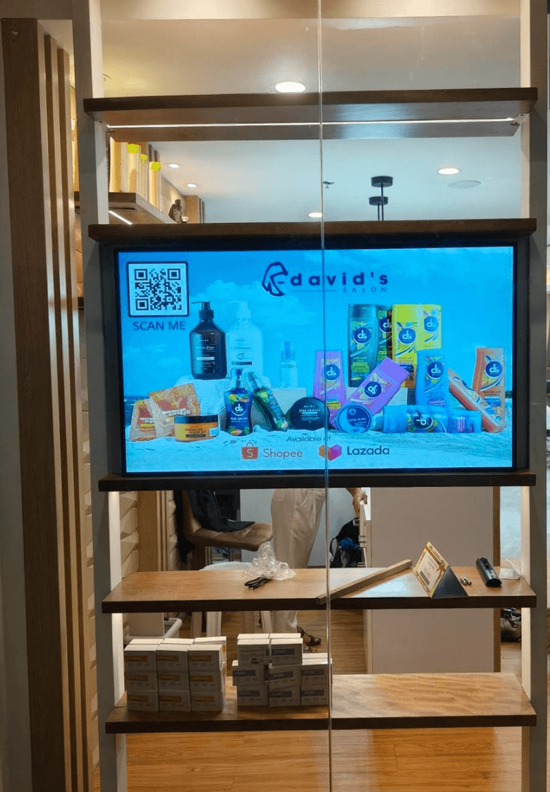 Android advertising screen in a store display shelf playing a promotion with a QR code