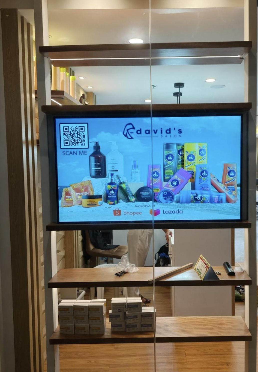 Android advertising screen in a store display shelf playing a promotion with a QR code