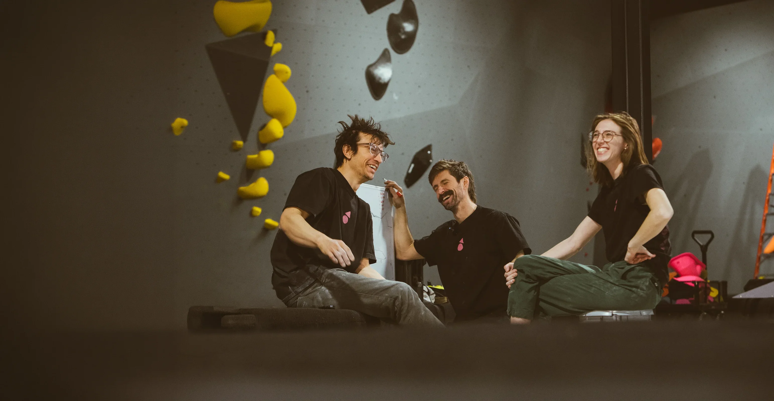 Group of climbers preparing to route set while laughing and having fun at Shift Climbing Gym