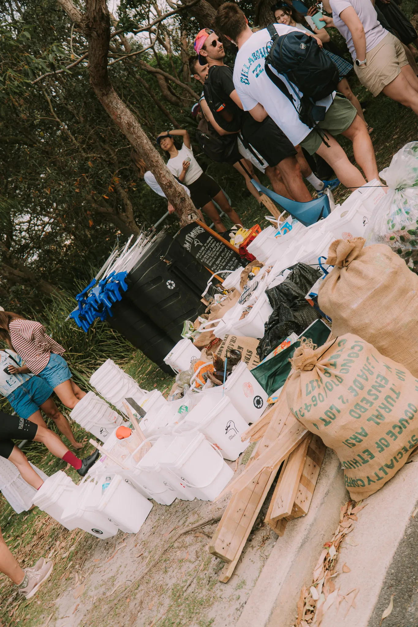 Beach clean-up with collected waste sorted on the sand