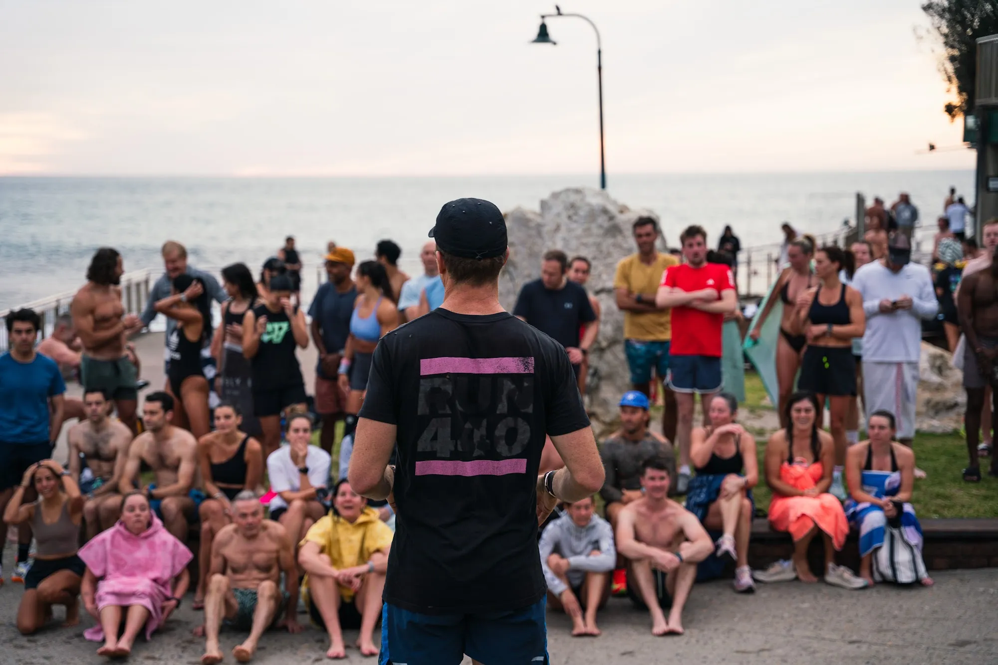The Pledge community gathered together on the beach at sunrise