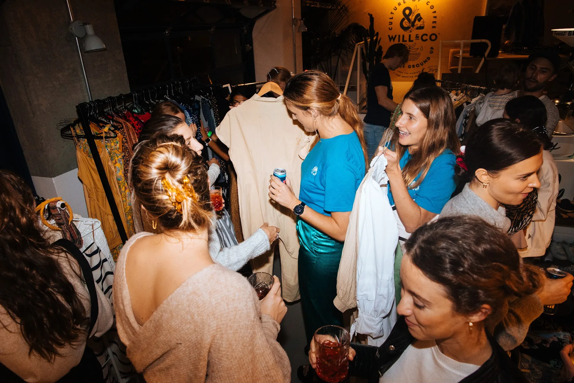 People browsing the rails at a Pledge clothes swap