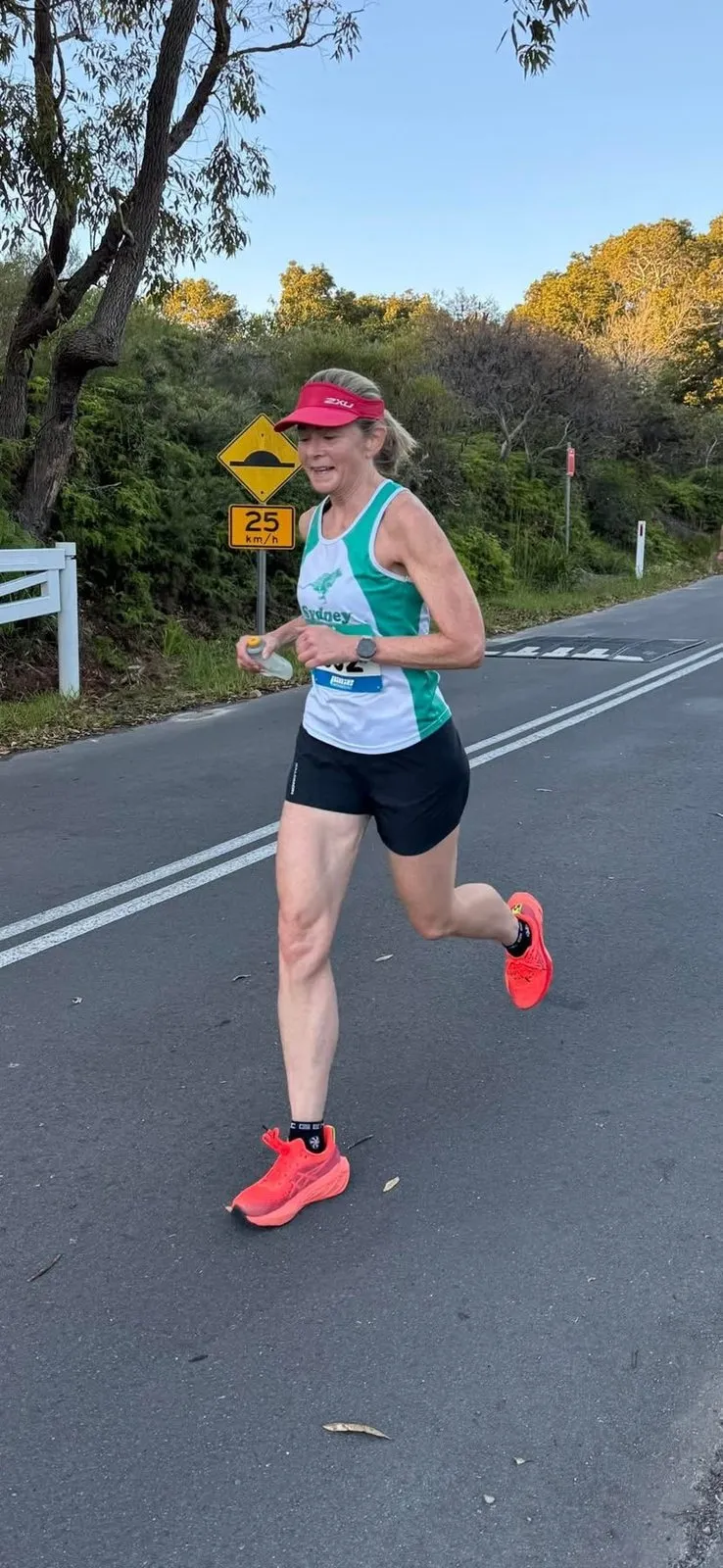 Kathryn Lowry running along a tree-lined road