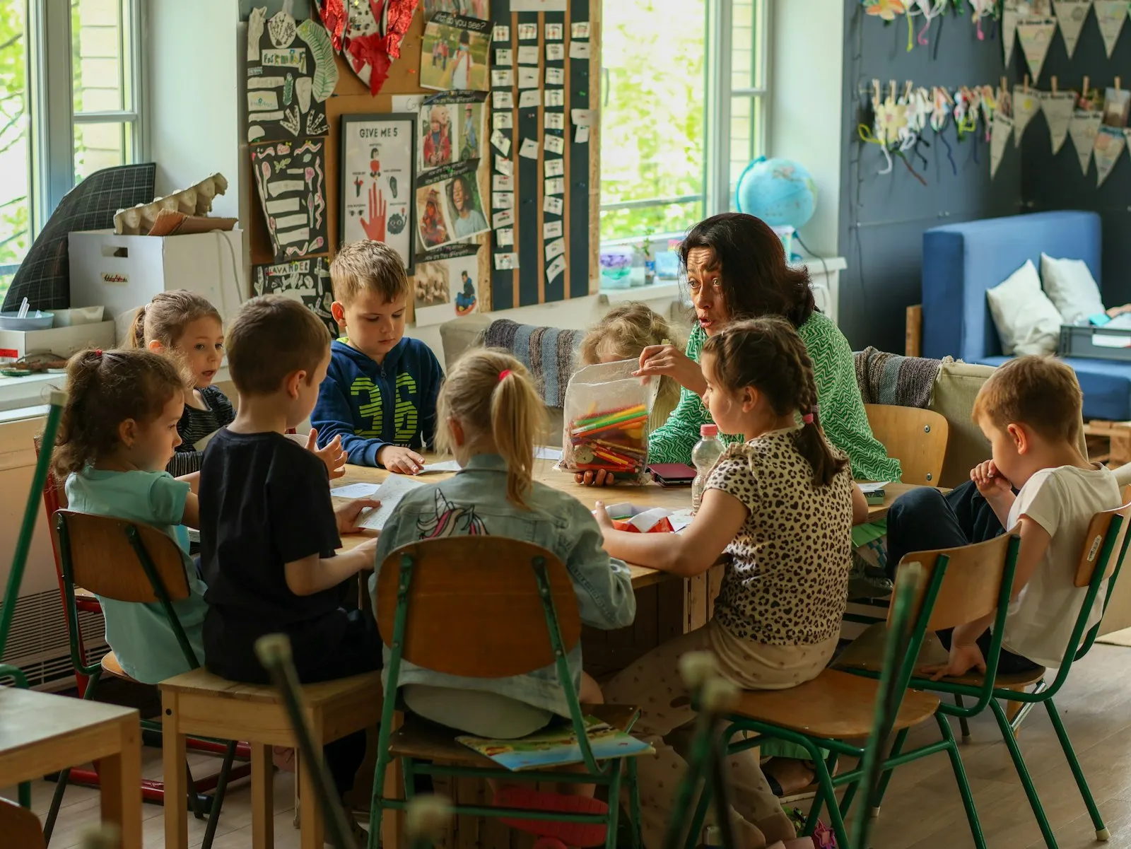 Teacher and students working together at a classroom table