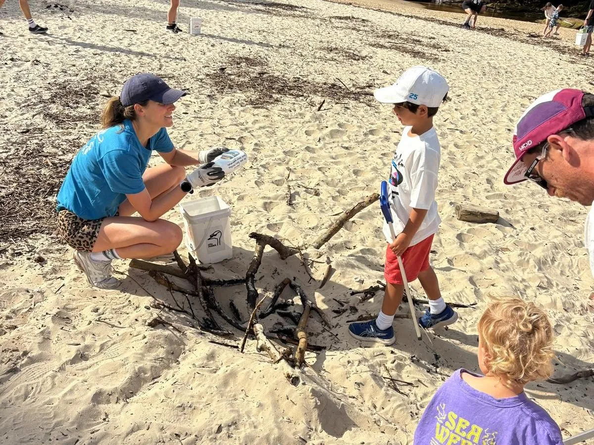 A teacher helping children with their work at a classroom table