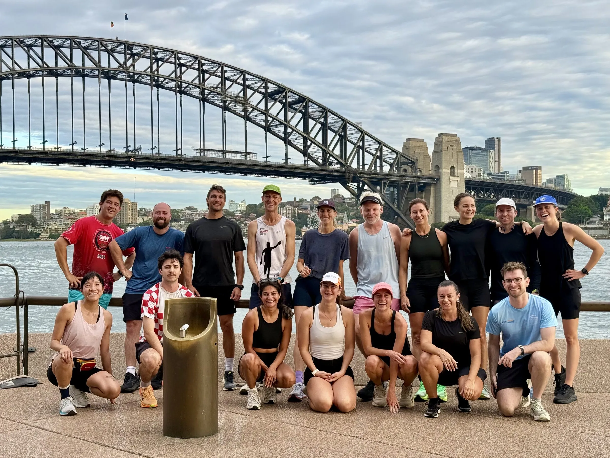 Large run group posing in an office lobby before a morning run
