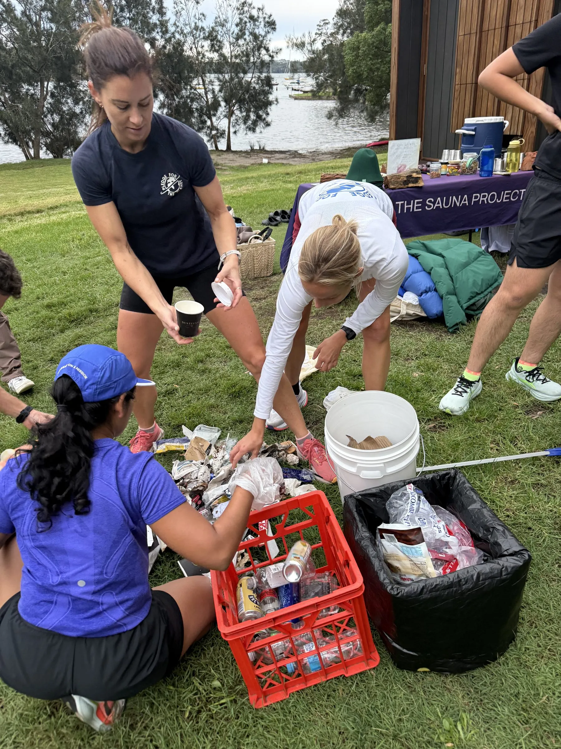 A Pledge waste warrior working the course as runners pass
