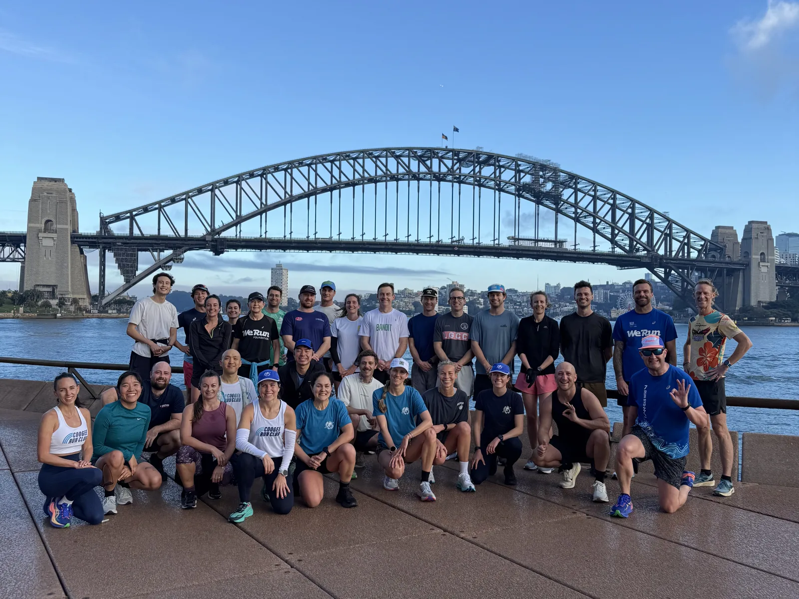 Pledge for the Planet runners and supporters gather for a group photo in front of the Sydney Harbour Bridge
