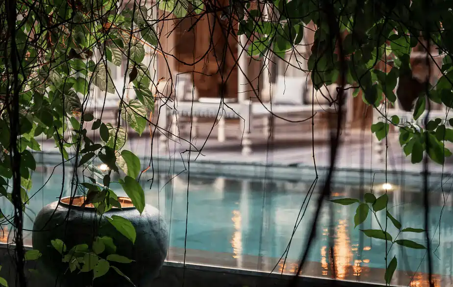 Serene swimming pool at Balquisse Heritage Hotel, a peaceful hotel in Jimbaran, Bali, offering a tranquil retreat amidst lush tropical gardens.