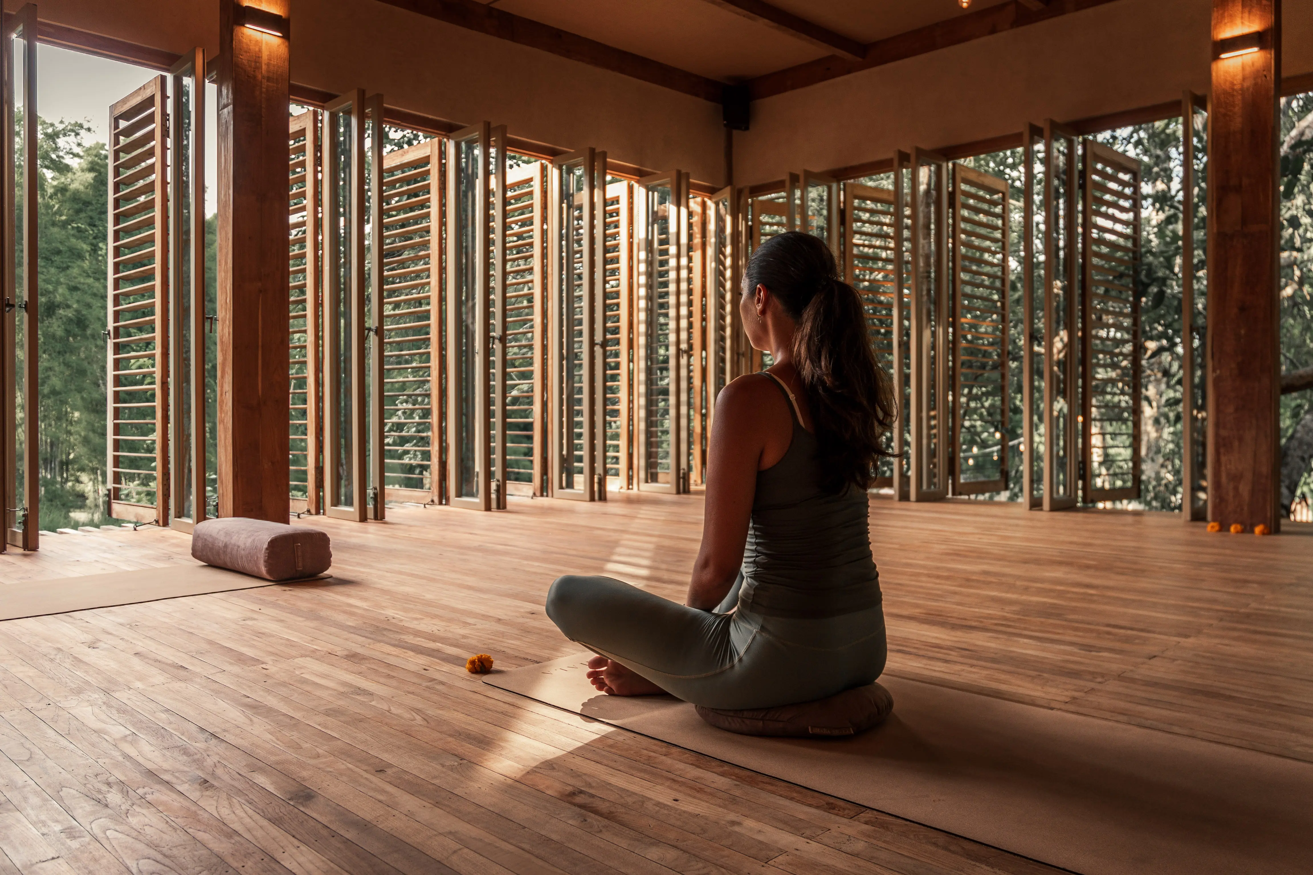 Find peace during meditation inside the wooden open-air studio of The Shaba Shala at Balquisse Heritage Hotel, Jimbaran, Bali.
