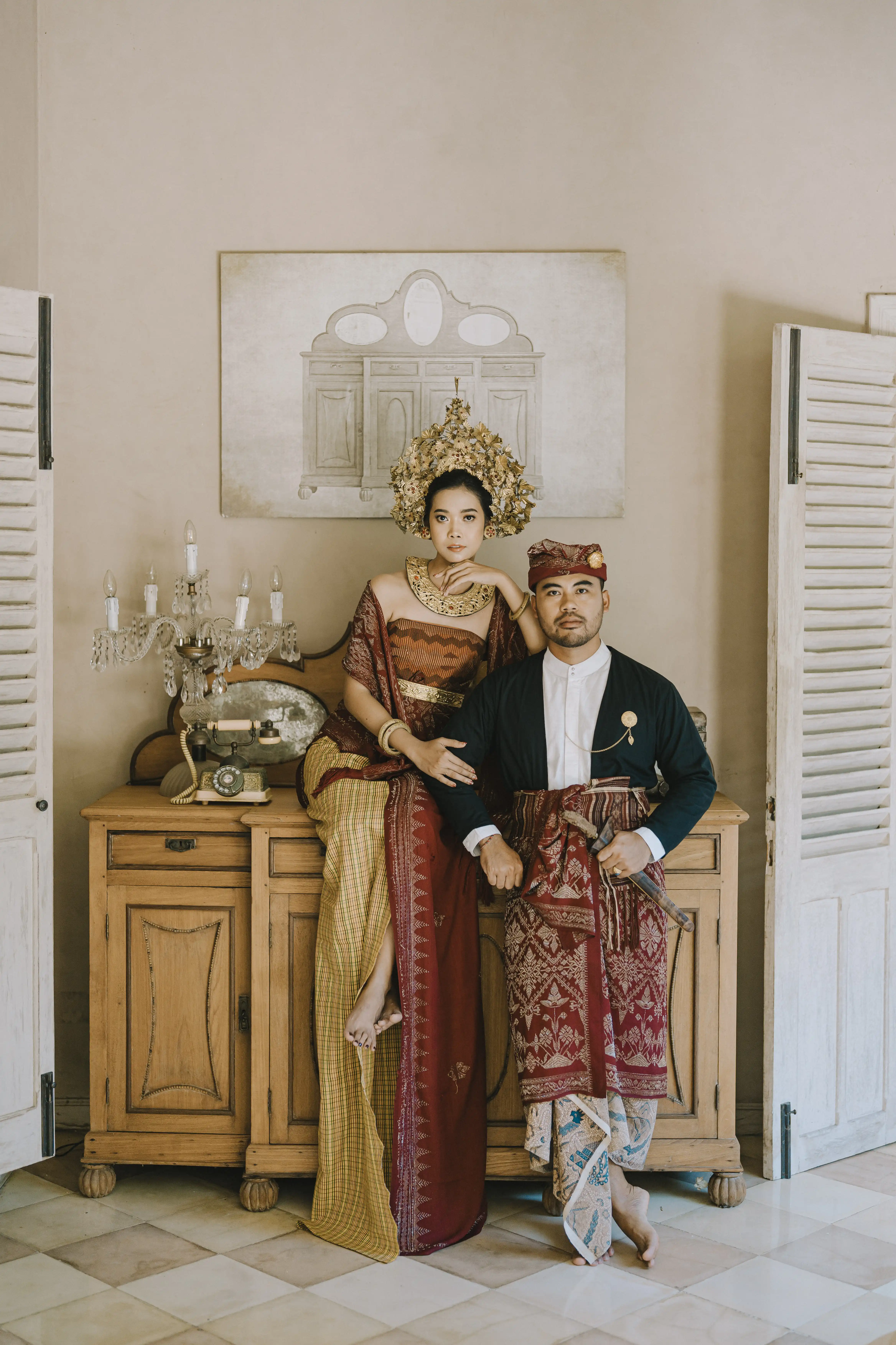 Traditional Balinese couple in ceremonial attire at Balquisse Heritage Hotel Jimbaran Bali, reflecting cultural charm of this unique boutique jimbaran hotel bali.