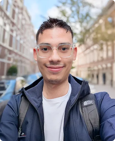 Portrait d'un selfie d'Etienne souriant dans une rue.