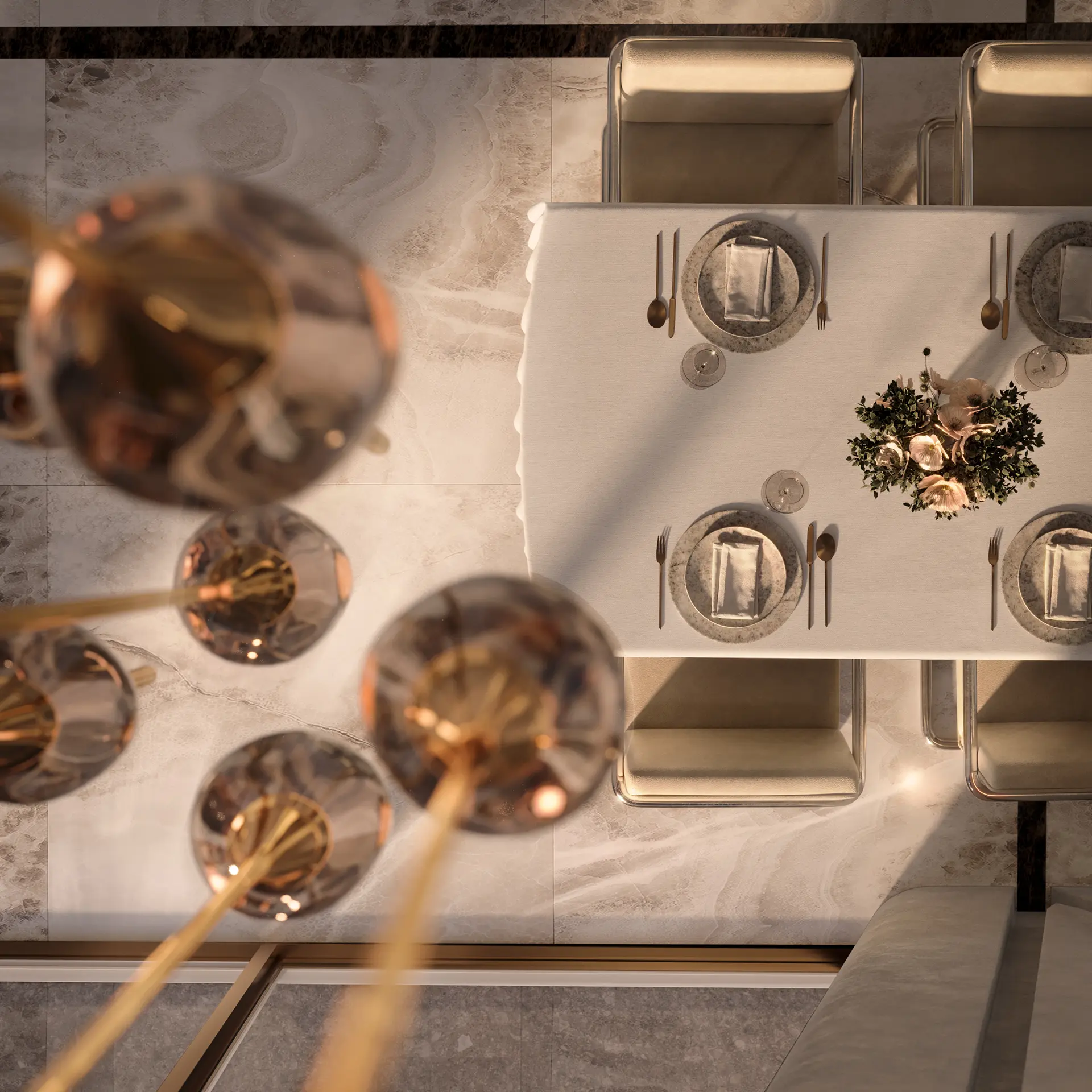 Overhead view of a formally set dining table with marble charger plates and brass-and-glass chandelier in foreground.
