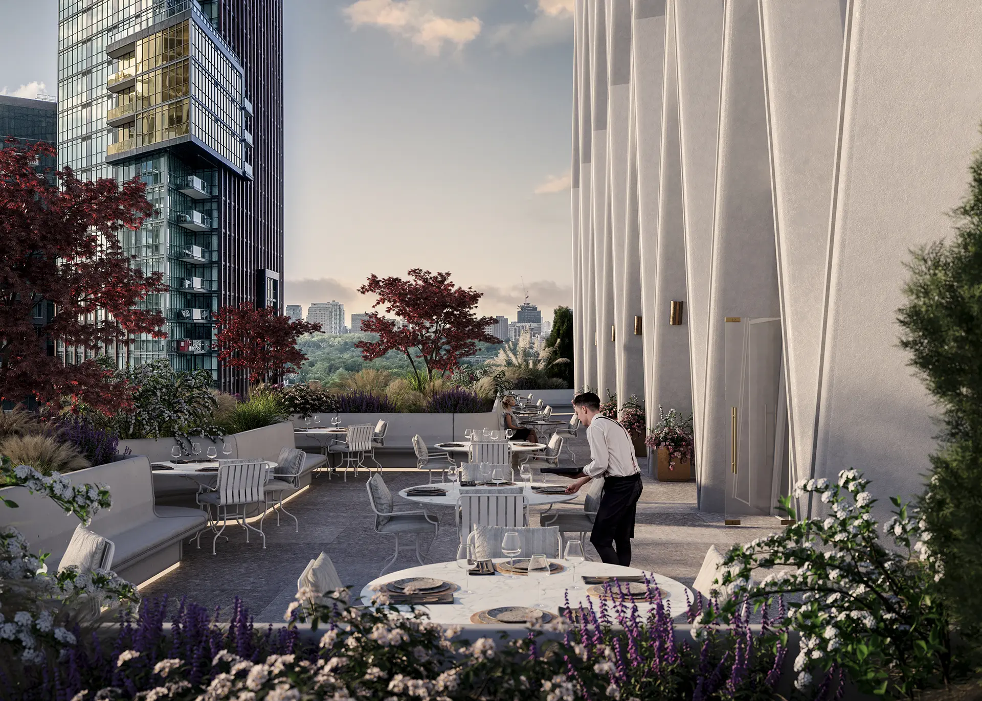 Rooftop terrace restaurant with white marble tables, lush landscaping, and panoramic city skyline at dusk.