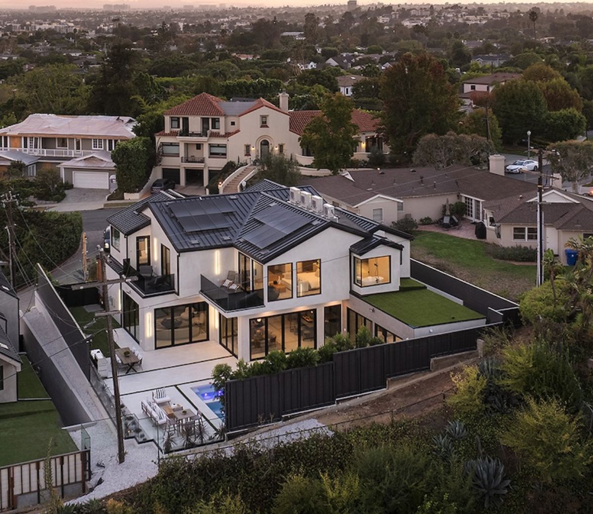 Aerial view of Cheviot Hills custom home — rooftop condensers beside the solar array
