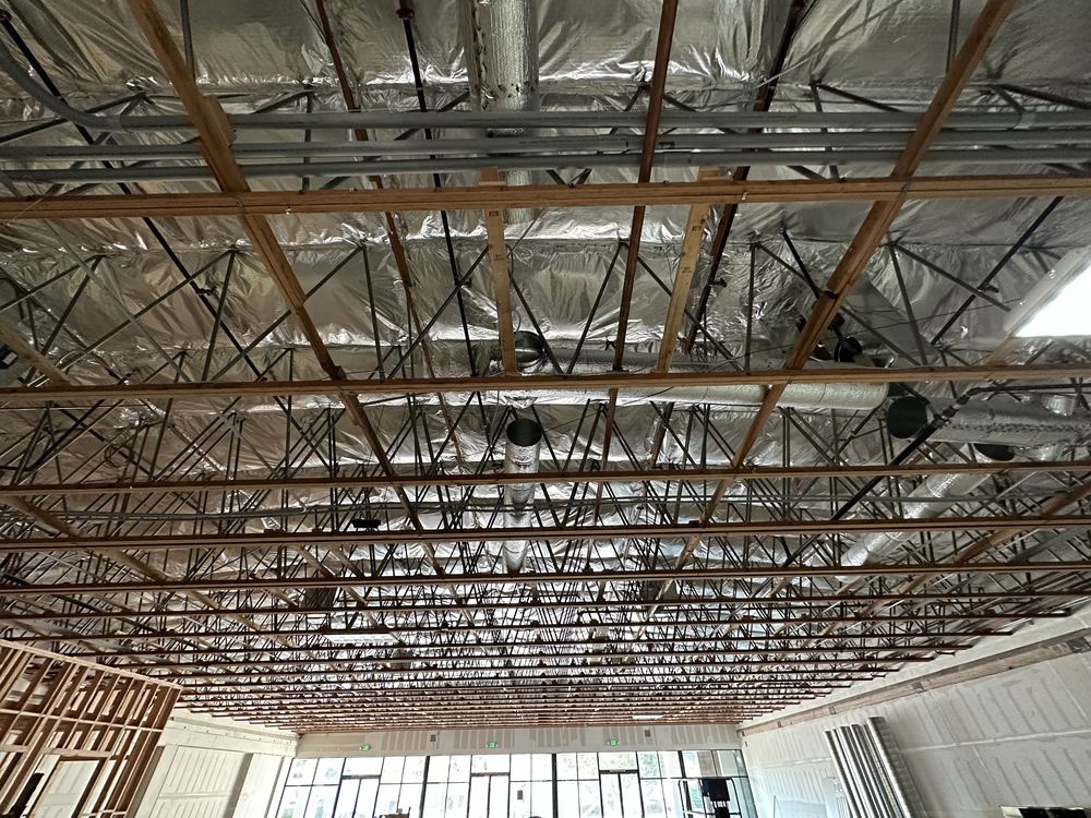 Ductwork installed through the open ceiling structure of an adult day health care facility — HVAC rough-in by Rhino Air